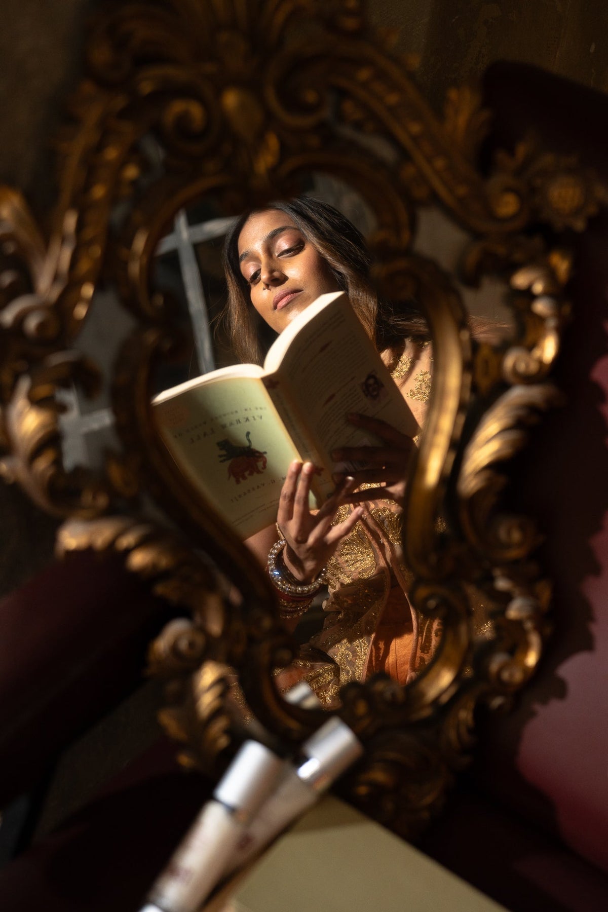 woman's reflection in a mirror reading about her hormonal skin