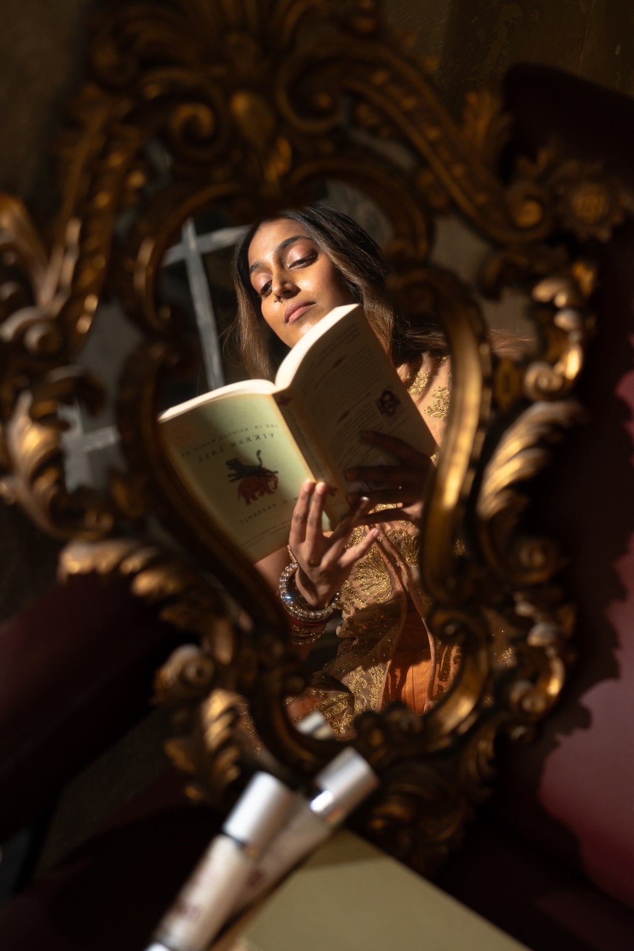woman's reflection in a mirror reading about her hormonal skin