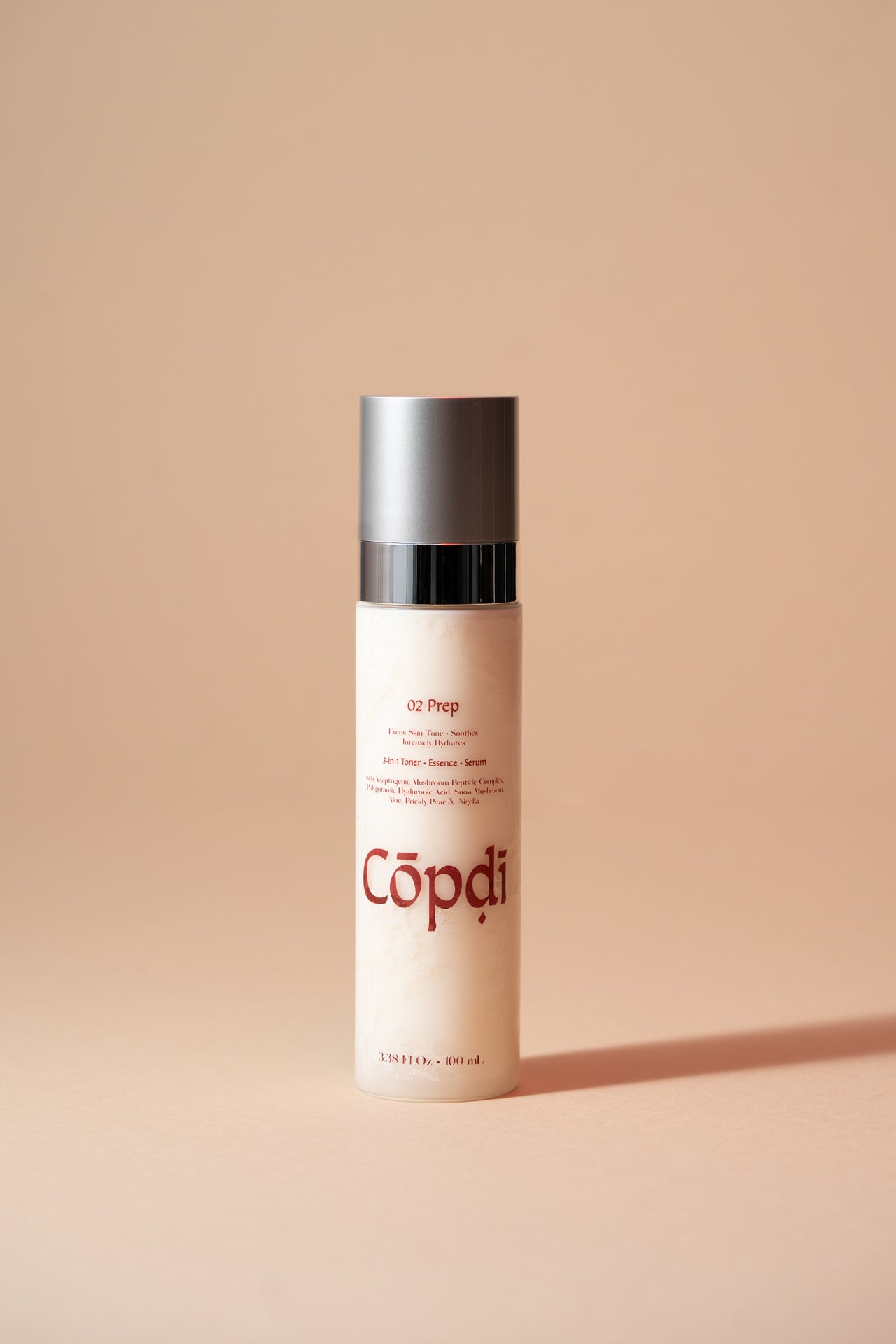 Skincare bottle labeled 'Copdi' on a beige background
